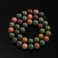 Polished dragon vein agate beads in a spiral arrangement on reflective black surface - 6.5mm (Approx. 57 Beads/Strand) / Alashan Agate