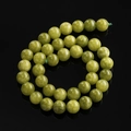 Gedetailleerd overzicht van groene drakenader agaat ronde kralen in een spiraalvorm - 6,5 mm (ca. 57 kralen/streng) / Peridot