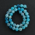 Macro shot of blue dragon vein agate beads with unique ice crackle patterns on dark background - 6mm (Approx 60 Pieces Per Strand) / Lake Blue