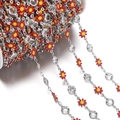 Detailed view of red enamel daisy chain with crystals on a white spool for DIY jewelry - Daisy Chain White K Red (7.5x12.5mm)