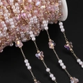 Macro shot of pink crystal butterfly and pearl copper chain on a white spool - 1m / KC Gold Pink