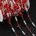 Close-up of red butterfly crystals and pearls on a gold chain for DIY jewelry making - 1m / KC Gold Red