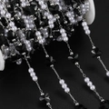 Macro detail of DIY jewelry chain with black butterfly beads and white pearls on a spool - 1m / Silver Black