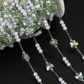 Macro detail of light green butterfly glass beads and white pearls on silver DIY chain - 1m / Silver/Green
