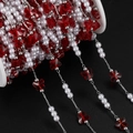 Detailed view of DIY bead chain with red butterfly charms and white pearls on a silver spool - 1m / Silver Red