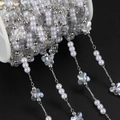 Detail of DIY jewelry chain with white pearls and butterfly charms on a spool - 1m / Silver White