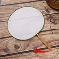 Detail of traditional Chinese round fan with green piping, bamboo handle and red tassel - Approx 25*34.5cm