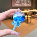 Close-up of blue liquid quicksand lollipop keychain with sequins and bow detail - No Keychain / Blue Color Bean Lollipop