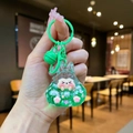 Detail of green liquid sand keychain with glitters pearls and bell in close-up view - Colorful Hardware Keychain Style / Luminous Burst Flashing Tata (Green)