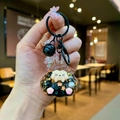 Detail of creative resin keychain with gold leaf stars and cute cartoon character - Colorful Hardware Keychain Style / Luminous Burst Flashing Tata (Black)