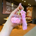 Detail of pink Sakura keychain with quicksand capsule and silicone wrist strap - Quicksand TV / Sakura Strap (Pink)