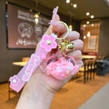 Close-up of heart-shaped liquid glitter keychain with Sakura wrist strap and bell - Sakura Strap Pink