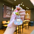 Detail of cute acrylic rabbit keychain with pink wristband, liquid glitter, and gold bell - Leather Strap Keychain Style / Luminous Burst Flashing Tata (White)