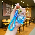 Blue glitter liquid bear keychain with silicone hand strap and bell, handheld detail - Wristband Blue Quicksand Turtle