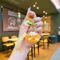 Detail of cute acrylic liquid oil bunny keychain with golden bell and pink charm strap - Leather Strap Keychain Style / Luminous Burst Flashing Tata (Orange)