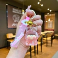 Detailed view of pink liquid quicksand keychain with Sweet Heart strap and gold bell - Leather Cord Style / Pink