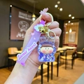 Detail of purple acrylic liquid quicksand keychain with sweet heart strap and gold bell - Leather Cord Style / Purple