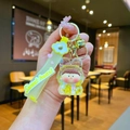 Detail of yellow resin astronaut keychain with glitter, bell, and Sweet heart wrist strap - Leather Cord Style / Yellow
