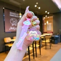 Detailed shot of pink cartoon cat liquid sand keychain with wrist strap and golden bell - Colorful (With Strap)