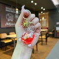 Cute bear liquid sand keychain in red resin with gold glitter and small bell - Red