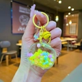 Detailed macro view of yellow acrylic TV keychain with colorful beads and liquid sand - Lobster Clasp Style / Yellow