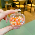 Pink suitcase shaped AirPods case with purple snowflakes and liquid glitter - Quicksand TV / No Buckle (Orange)