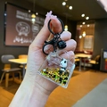 Close-up of a panda liquid acrylic keychain with gold stars and black matte hardware - Lobster Clasp Style / Black Hardware [Purse] Black Gold Panda