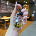 Close-up of a panda liquid keychain with golden stars and a black bell accessory - Lobster Clasp Style / Black Hardware [Alarm Clock] Black Gold Panda