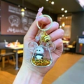 Close-up of a panda quicksand keychain with gold star glitter and acrylic bear ears - Lobster Clasp Style / Gold Hardware Bear Head Black Gold Panda