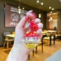 Creative red zodiac dragon keychain with moving gold beads in a sycee pendant - Red (Red Hardware)
