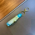 Blue and yellow gradient silicone keychain with Bubble lettering and gold metal ring - Blue