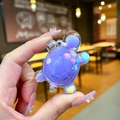 Close-up of a mini turtle charm with purple liquid and colorful beads inside - Small Milk Bean Turtle / 1 Piece / Purple
