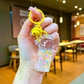 Macro detail of yellow drifting bottle keychain with flowing glitters and small bell - Luminous Bubble Bead (Colored Hardware) / Lobster Clasp Style / Yellow