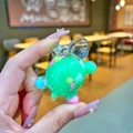 Macro shot of green acrylic turtle charm with floating liquid and colorful sand detail - Small Milk Bean Turtle / 1 Piece / Green