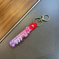 Detail of purple gradient silicone wristlet strap with Bubble lettering and gold hardware - Red