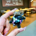 Macro detail of a transparent acrylic turtle charm with colorful interior beads - Small Milk Bean Turtle / 1 Piece / Black