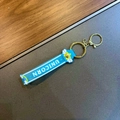 Blue silicone unicorn wristband keychain with rainbow motifs and gold metal hardware - Blue Rainbow Wing Lanyard