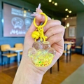 Macro detail of yellow cat paw liquid keychain with star sequins and metallic bell ring - Lobster Clasp Style / Yellow