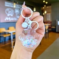Macro view of cute cat paw acrylic keychain with colorful star sequins and fine glitter - Lobster Clasp Style / White