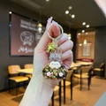 Luminous glitter liquid cat keychain with gold sequins in a clear resin finish - Gold Hardware Keychain Style / Luminous Burst Flashing Tata (Black)
