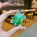 Green turtle-shaped pendant with pink cherry blossom sequins and golden glitter - Small Glow Flash Turtle / 1 Piece / Green