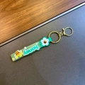 Close-up of green soft PVC keychain strap with white honey text and bee charm - Little Bee Strap / 1 Piece / Green