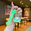 Close-up of Sakura theme keychain with green resin rabbit, glitter and silicone wrist strap - Leather Strap Keychain Style / Luminous Bubble Beads Tata (Green)