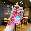 Portachiavi a tema Sakura rosa con ciondolo a bambola e campanellino dorato - Stile Statuina Mela con Bolle Luminose e Corda Sakura / Rosso