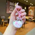 Porte-clés cœur lumineux avec paillettes roses et flocons tenu à la main - Style Fermoir Mousqueton / Métal Coloré (Blanc)
