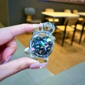 Macro view of a clear resin turtle charm filled with blue glitter balls and sequins - Black Luminous Bubble Bead Turtle