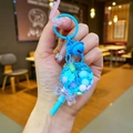 Lollipop liquid keychain with colorful beads, sequins, and a blue bow charm - Blue