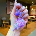 Purple lollipop liquid keychain with colorful beads, sequins and a matching bell - Purple