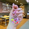 Kreativer Schlüsselanhänger mit Regenbogenperlen und schwimmenden Sternen und rosa Glocke - Sonnenblumenform