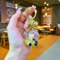 Creative bubble tea keychain with floating bear and yellow liquid sand in a golden ring - Lobster Clasp Style / Soda Bottle Style
